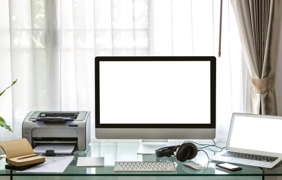 Modern home office with computer and laptop